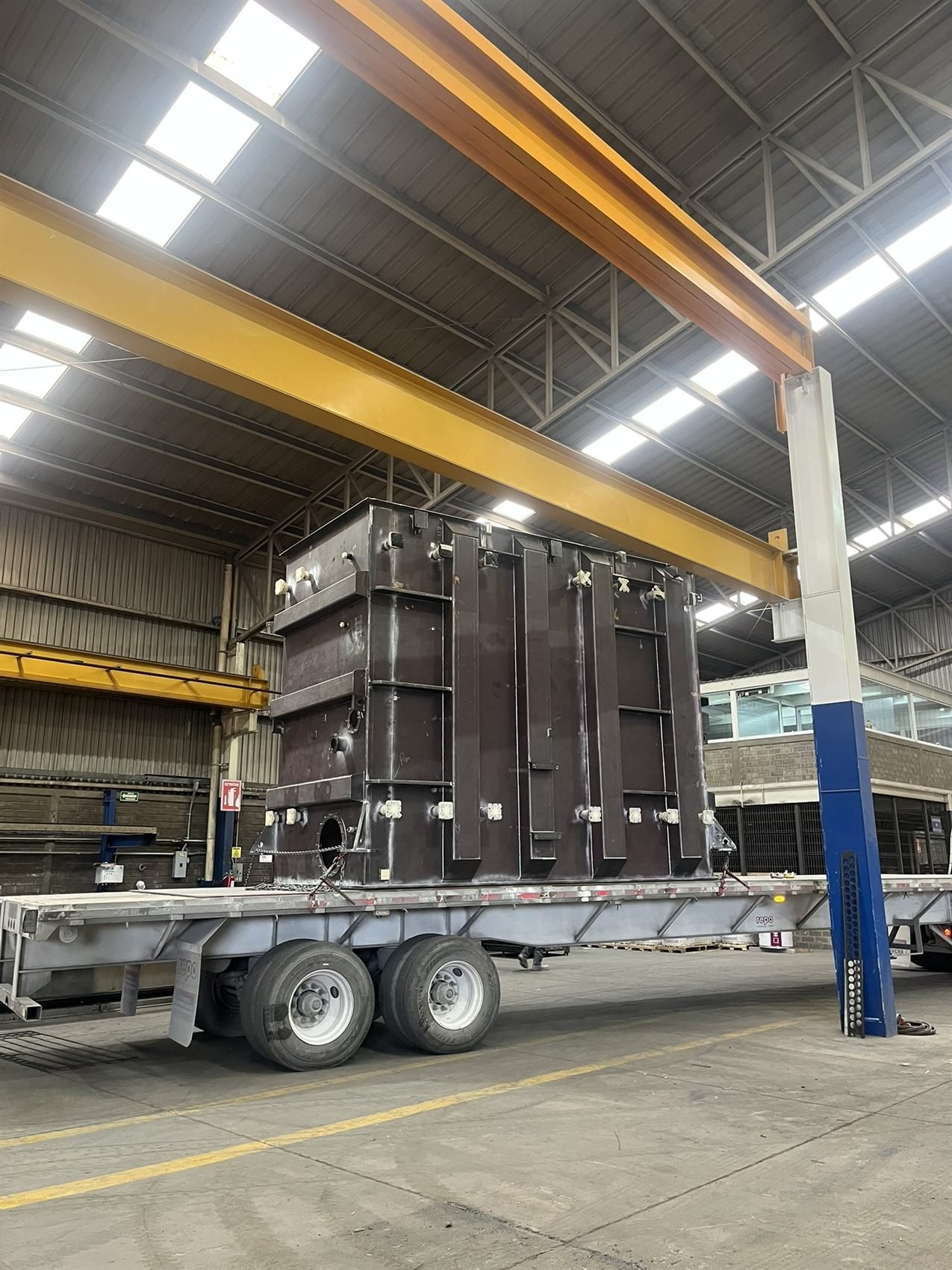 Transformer tank loaded under overhead crane